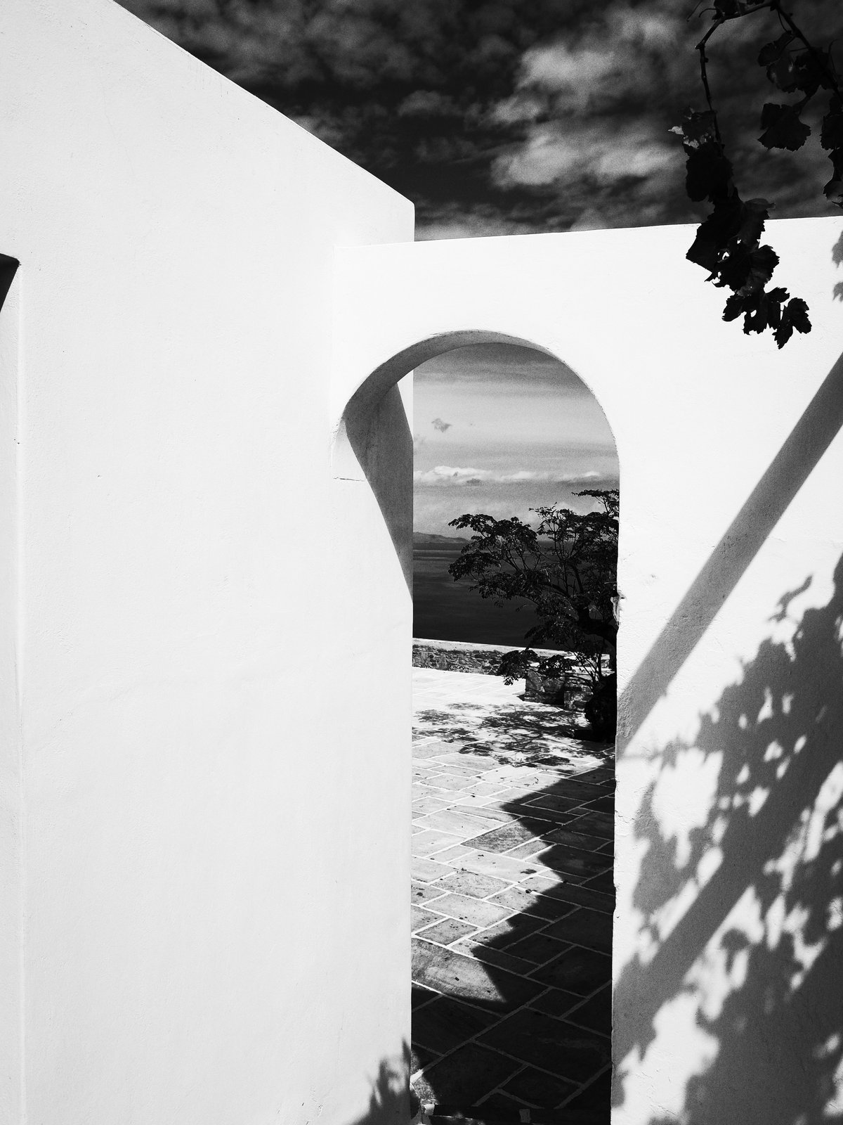 Black and white Cycladic arch framing the sea — limited edition print